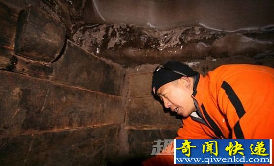 一名队员正在查看一座木制结构的部分